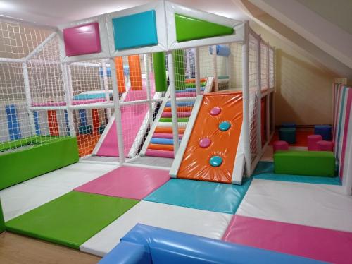 a play room with a slide and play equipment at Konaciste Pepa in Divčibare