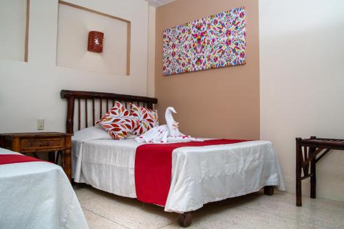Ένα ή περισσότερα κρεβάτια σε δωμάτιο στο Hotel Zihua Caracol