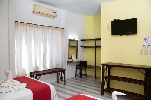 Ένα ή περισσότερα κρεβάτια σε δωμάτιο στο Hotel Zihua Caracol