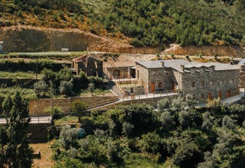 an aerial view of a large stone building in a field at Casas do Oiteirinho in Arganil