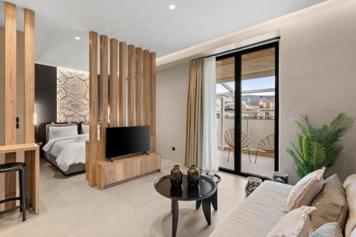a bedroom with a bed and a tv in a room at ACRON 12 penthouse Acropolis suites in Athens