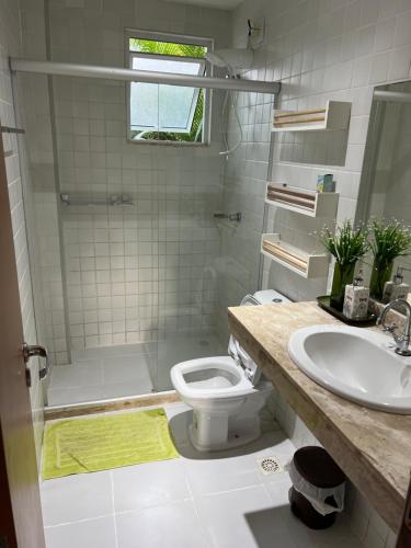 a bathroom with a sink and a toilet and a shower at Condominio reserva imbassai in Mata de Sao Joao