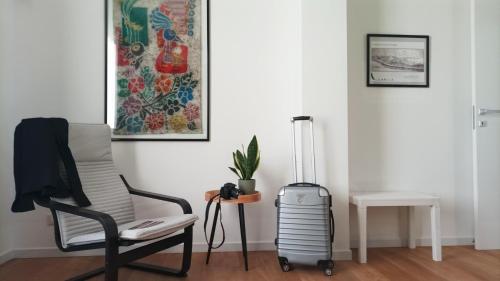 a living room with a chair and a suitcase at Casa D'Antò in Petralia Sottana