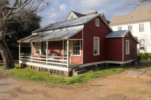 an old red house with a solar roof at Wensel Cottage in downtown Natchez in Natchez