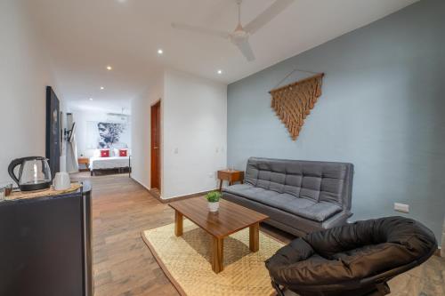 a living room with a couch and a table at Casa Fersan in Cancún