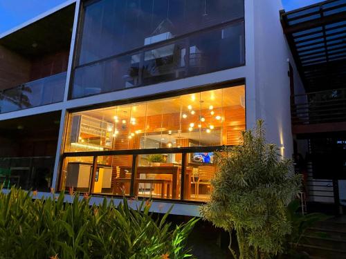 a large window of a building with lights in it at EXCLUSIVE RESIDENCE, BARRA GRANDE, PENINSULA DE MARAÚ in Barra Grande