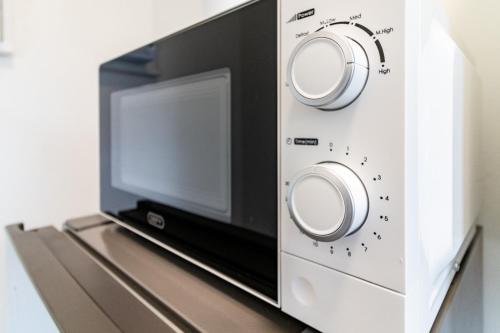 a microwave oven sitting on top of a table at Wavecrest 103 Holiday Apartment in Durban