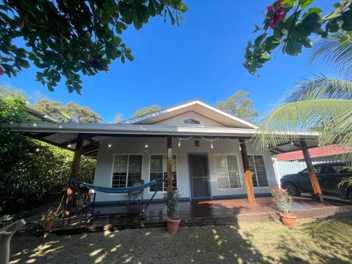 a house with a porch with a blue hammock on it at Casa Gato in Big Creek