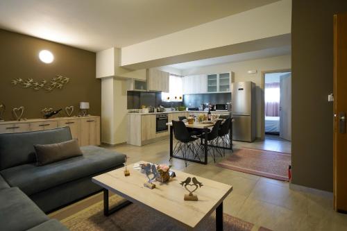 a living room with a couch and a table at Theo and MS Luxurious Apartments in Kos Town