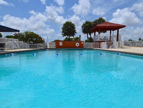a large blue swimming pool with a gazebo at 13101 Main Apartment 1 Miami in Miami