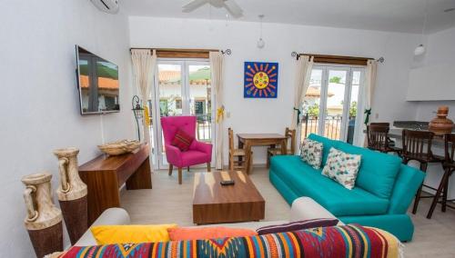 a living room with a couch and a table at Refugio del Mar Luxury Hotel Boutique in Bucerías