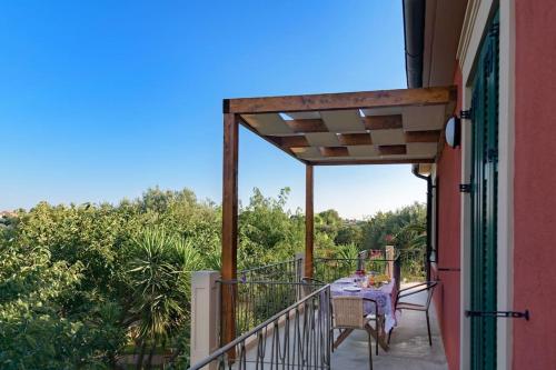 a balcony with a table and chairs on it at N A P L house in Keramiaí