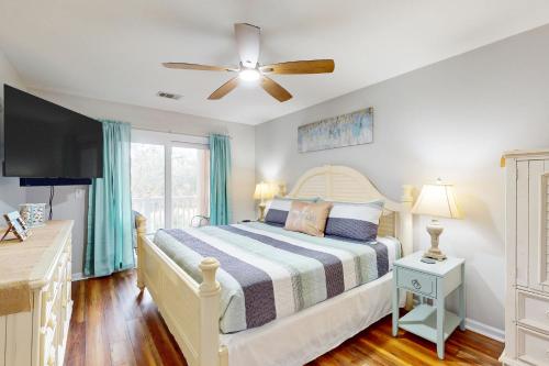 a bedroom with a bed and a ceiling fan at Our Beach House Retreat in Myrtle Beach