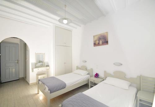 A bed or beds in a room at Dimitra Pension