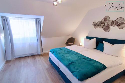 a bedroom with a bed and a large window at Homely Stay - Urban Oasis Apartments in Moosburg