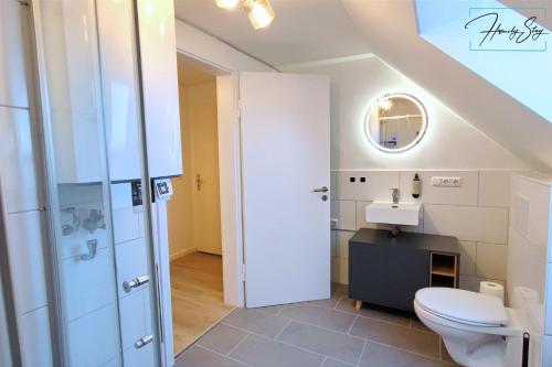 uma casa de banho com um WC e um lavatório em Homely Stay - Urban Oasis Apartments em Moosburg