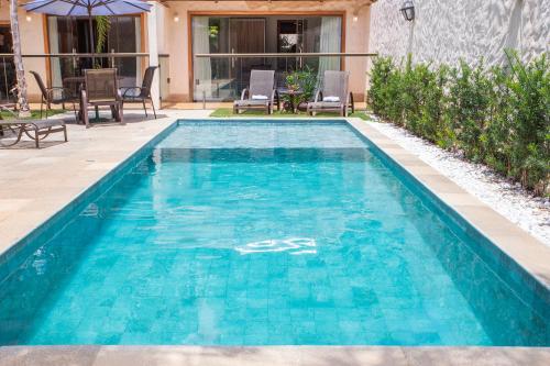 a swimming pool with blue water in a yard at Pousada Cavaleiro dos Pireneus in Pirenópolis