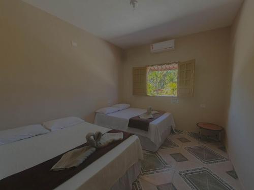 Ένα ή περισσότερα κρεβάτια σε δωμάτιο στο Xaréu Flats: Aluguel de Temporada à Beira-Mar!