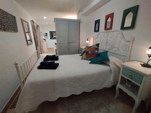 a bedroom with a large white bed with pillows on it at Casa Altuna in Pinos Genil