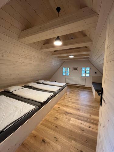 a row of beds in a room with wooden floors at Antoniwald82 Josefův Důl in Josefuv dul
