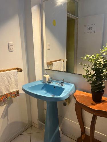 a bathroom with a blue sink and a mirror at Espacio Mycelium in Coihaique