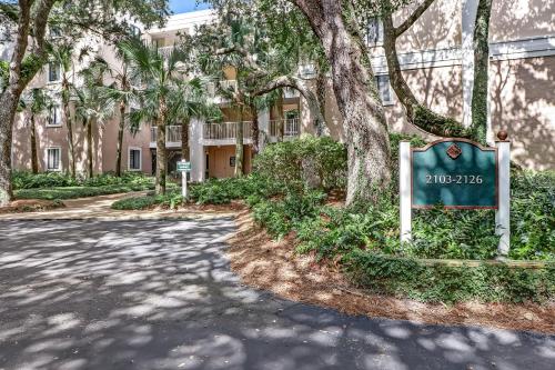 a street sign in front of a building with trees at 2107 Beach Wood in Amelia Island