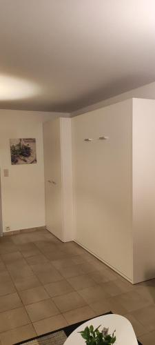 an empty room with white walls and a tile floor at SEAVIEW STUDIO WESTCLIFF in Blankenberge