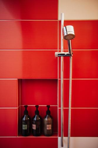 a row of alcohol bottles on a shelf in a bathroom at Award-Winning Modern Retreat with Hot Tub & Views in Queenstown