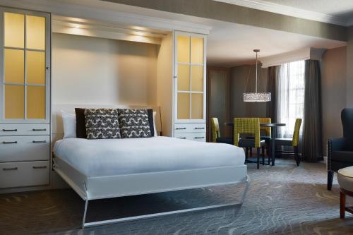 a bedroom with a bed and a dining room at Gaylord Opryland Resort & Convention Center in Nashville