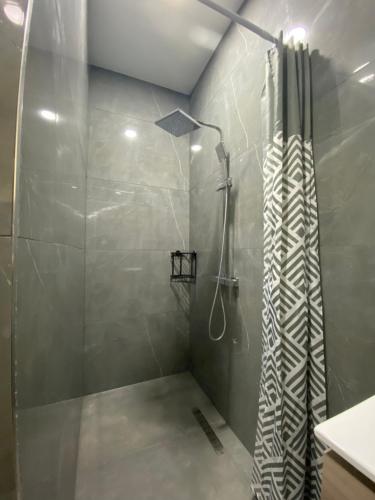a bathroom with a shower with a shower curtain at Kappas place HENDRIKA J VELDKAMPSTRAAT 55 in Paramaribo