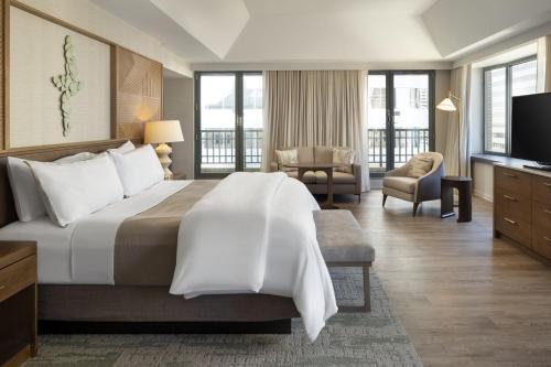 a hotel room with a large bed and a television at The Westin Denver Downtown in Denver