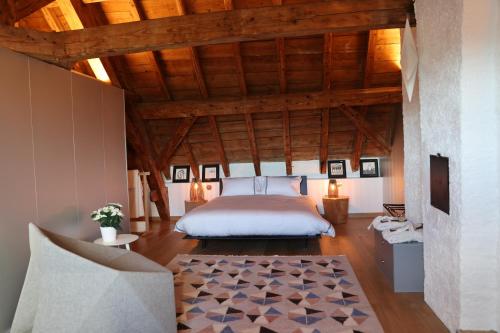 a bedroom with a bed and a wooden ceiling at Sessius1622 in Cessy