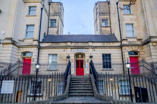 a building with a red door and stairs in front at Cozy Entire Flat with Gated Parking- Contractors, Family, Groups in Reading