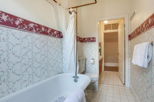 a bathroom with a bath tub and a toilet at Eclectic Sacramento Home about Half Mi to Downtown! in Sacramento