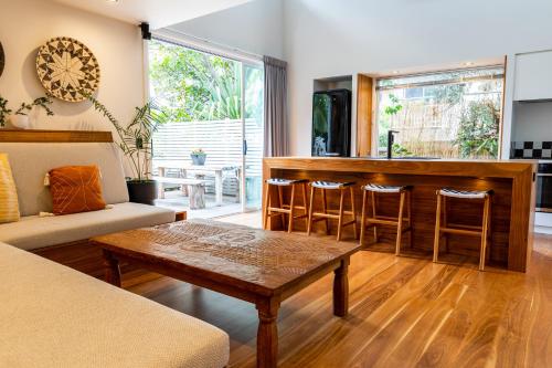a living room with a table and a bar at Indigo Charlee in Gold Coast