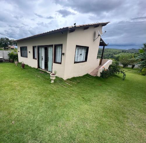 a small house with a grassy yard in front of it at Vista Verde Tiradentes in Tiradentes