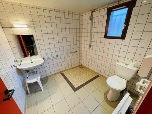ein Bad mit einem WC und einem Waschbecken in der Unterkunft Gîte de Painfaut pour 12 personnes in Avessac