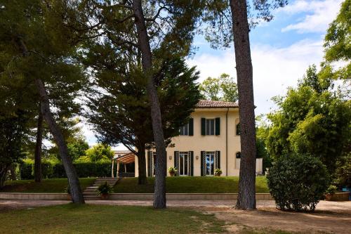 a house with trees in front of it at Villa Monacelli B&B in Fano