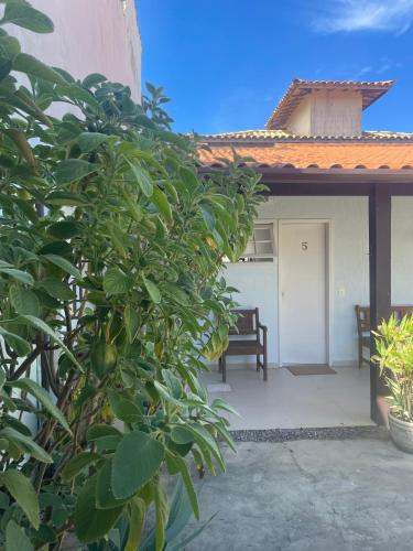 a porch of a house with a bench in front at Pousada El Camenito Geribá Búzios in Búzios