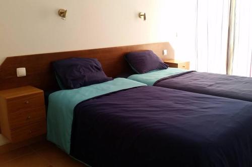 two beds sitting next to each other in a bedroom at Sesimbra Village T1 in Sesimbra