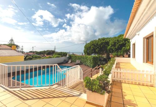a swimming pool on the balcony of a house at Family beach house, sea view, pool, Colares near Sintra in Colares