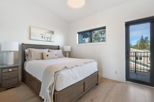 a bedroom with a bed and a window at Ocean's 7 at THE BEACH HOUSE in Campbell River