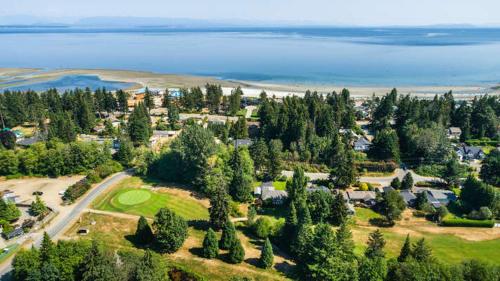 an aerial view of a park with trees and the ocean at Ocean's 7 at THE BEACH HOUSE in Campbell River
