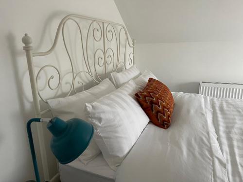 a white bed with white pillows and a white headboard at Luxury 2 Bed Apartment in Portadown