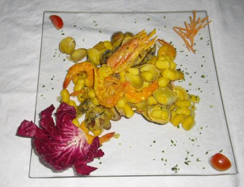 a white plate of vegetables on a table at Hotel Rurale Canneviè in Lido di Volano