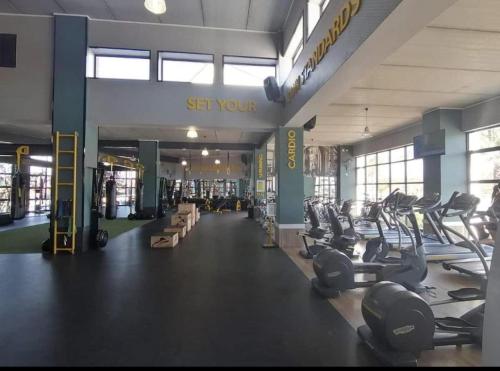 a gym with lots of treadmills and cardio machines at Tranquil Gateways-The blyde crystal lagoon in Pretoria