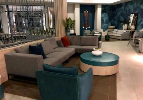 a living room with a couch and a table and chairs at Tranquil Gateways-The blyde crystal lagoon in Pretoria