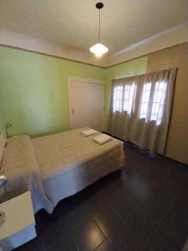 a bedroom with two beds and a window at Departamento Familiar km3 in Comodoro Rivadavia