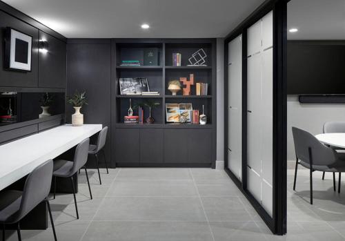 a dining room with black walls and a table and chairs at Level Seattle Downtown - South Lake Union in Seattle