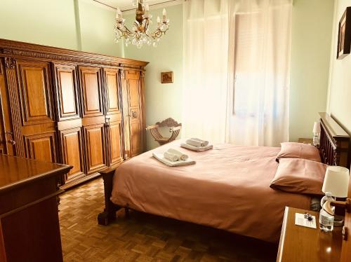 a bedroom with a large bed and a chandelier at Affittacamere Umberto&Marisa in Foligno